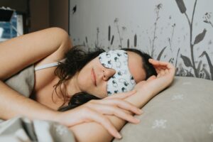 Person sleeping peacefully wearing a sleep mask, representing IV ketamine therapy for sleep in Lincoln Nebraska and nervous system regulation