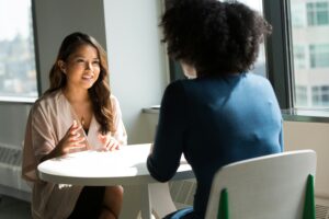Two women having a conversation representing mental health stigma and the importance of supportive discussions about emotional wellbeing