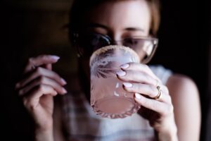 Woman with a drink for an article about ketamine for alcohol use disorder